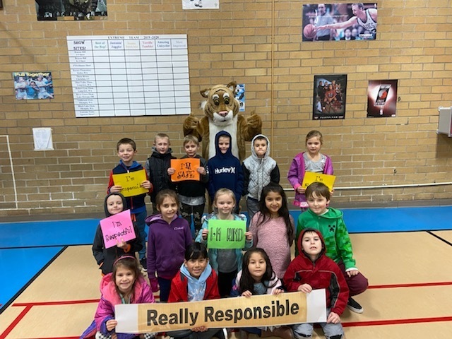 students holding signs about our Bobcat Beliefs